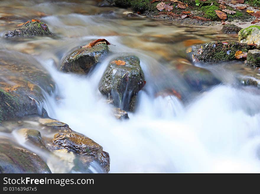 Landscape with mountain stream and cascades