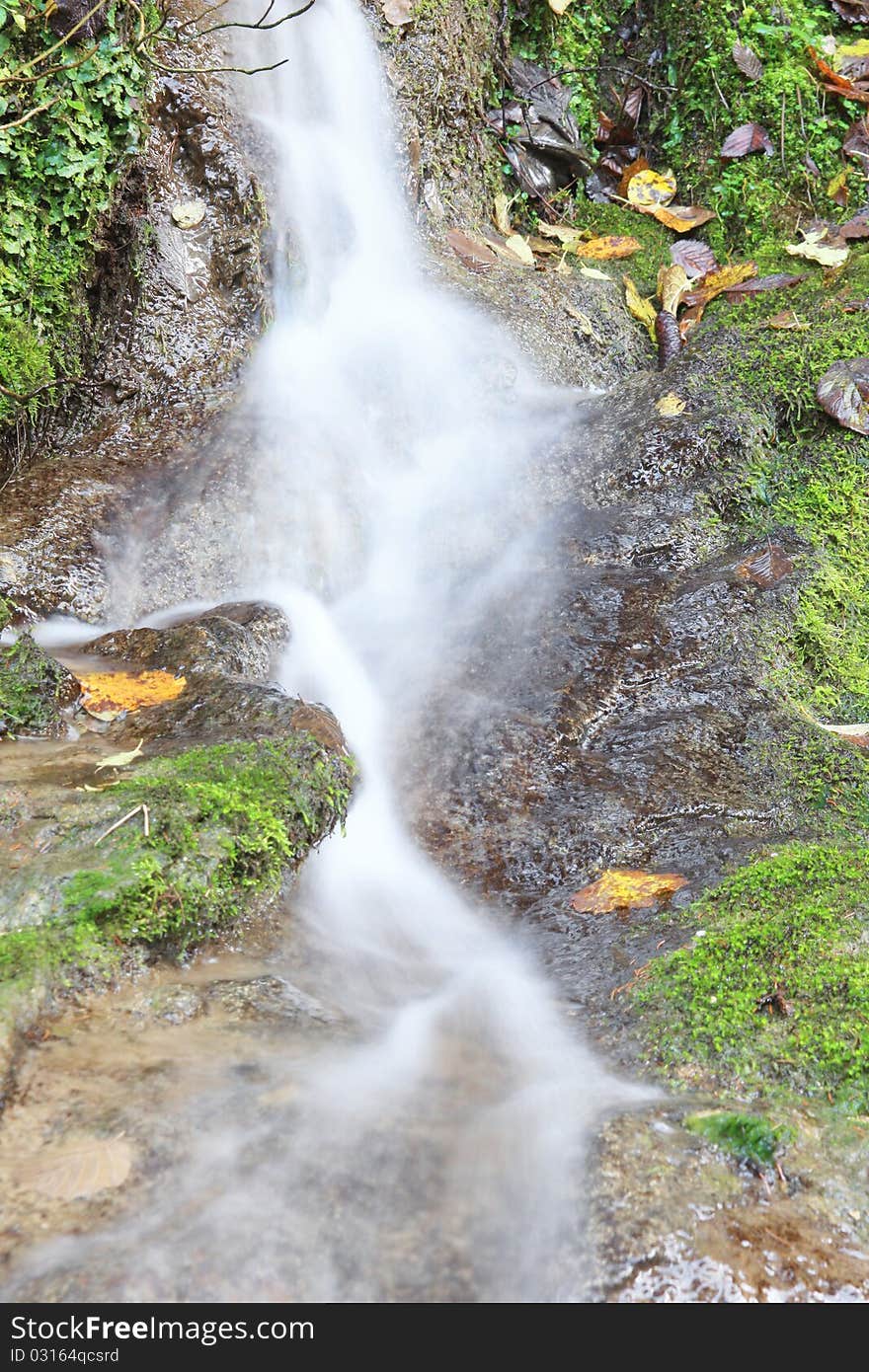 Landscape with mountain stream and cascades