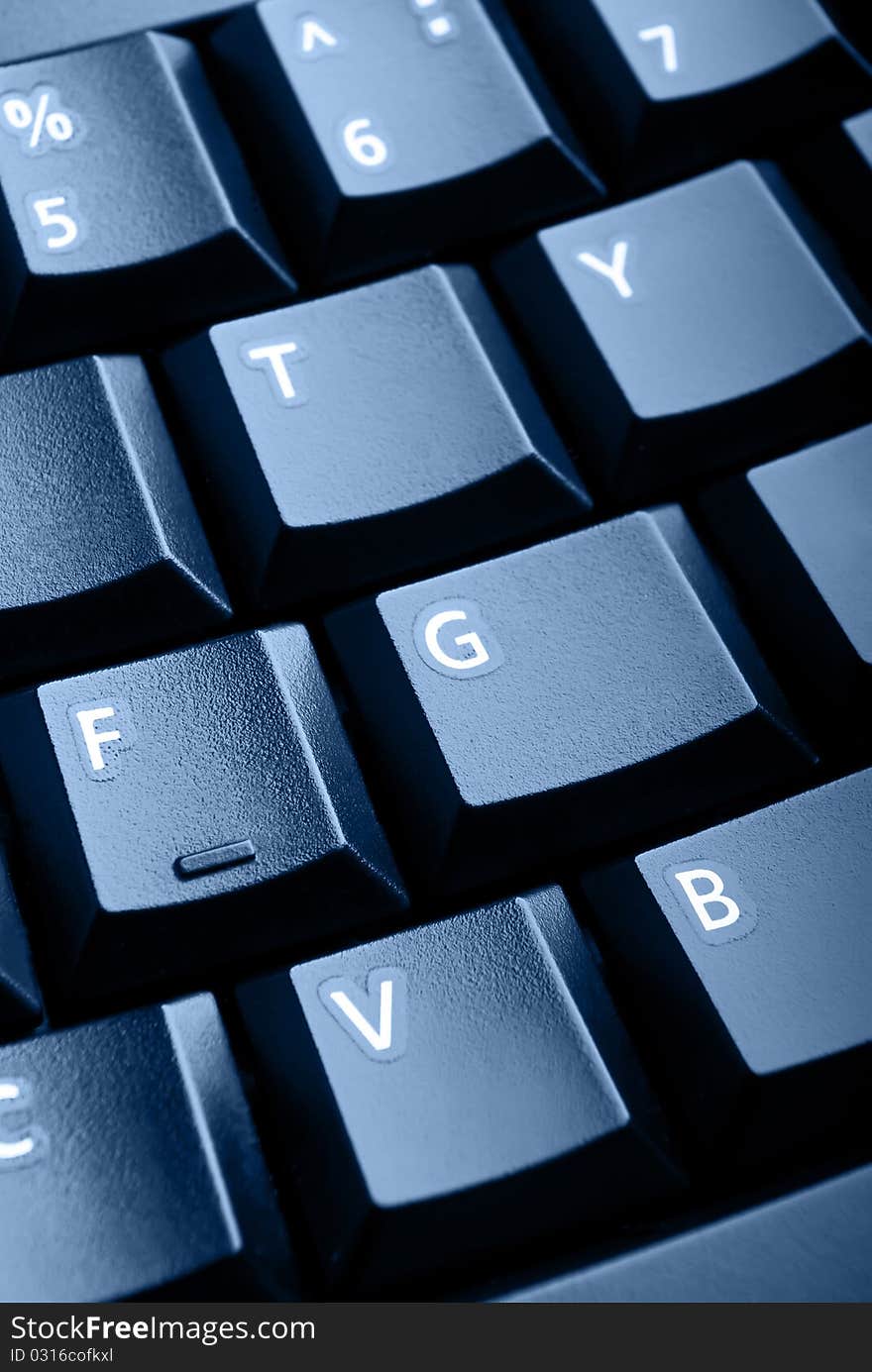 The keyboard pc is photographed by close up.Blue tonned. The keyboard pc is photographed by close up.Blue tonned