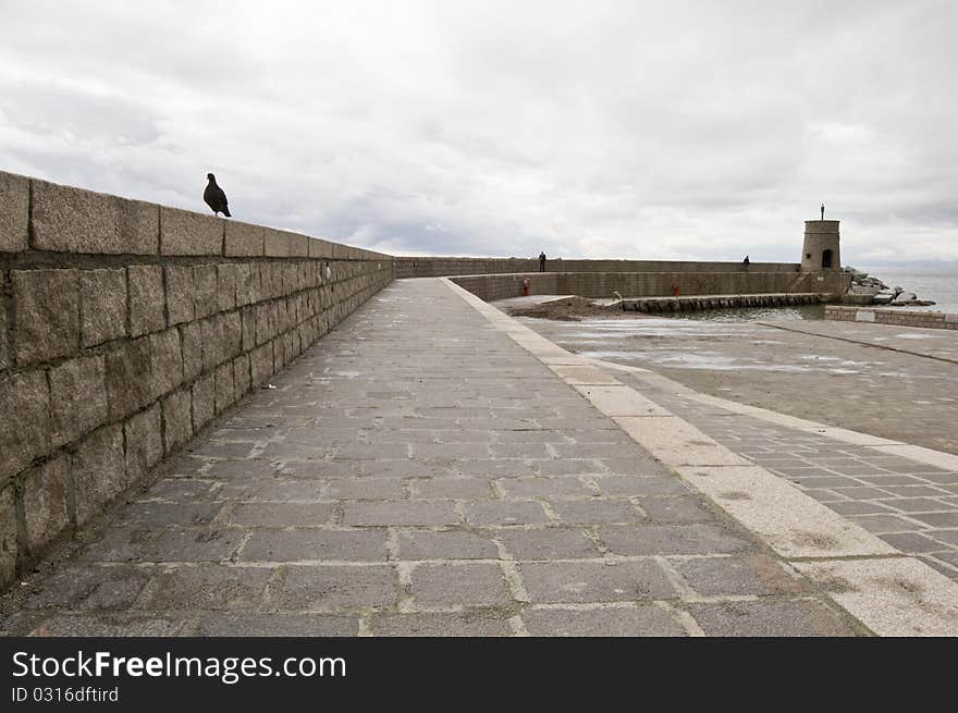 Pier in a cloudy day arouses melancholy