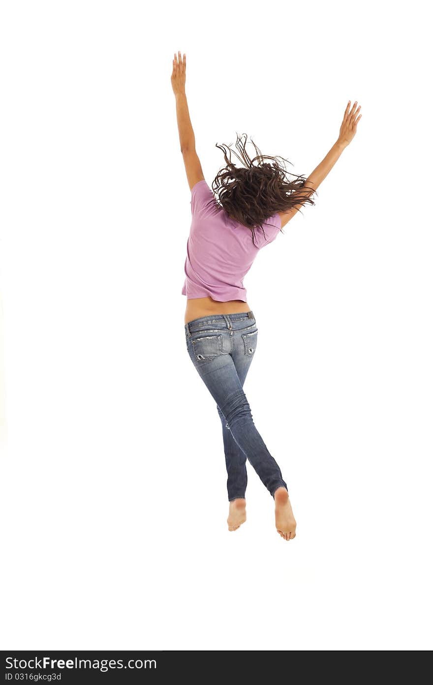 Cute young woman with jeans jumping energetically