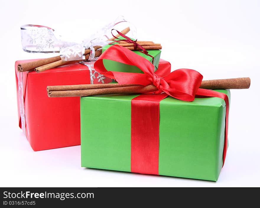 Gift with bows decorated with cinnamon sticks on white background. Gift with bows decorated with cinnamon sticks on white background