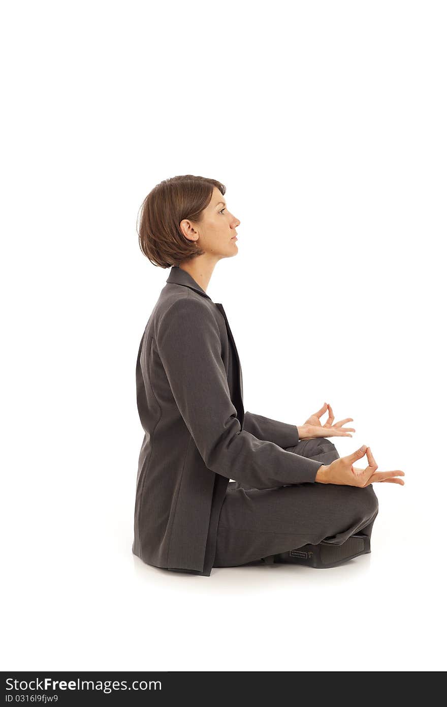 Young businesswoman in suit doing yoga. Young businesswoman in suit doing yoga