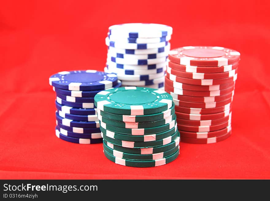 Poker chips for desktop background on red.