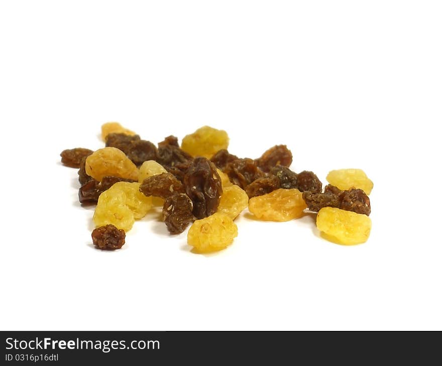 Yellow and brown raisin on the white isolate background. Yellow and brown raisin on the white isolate background