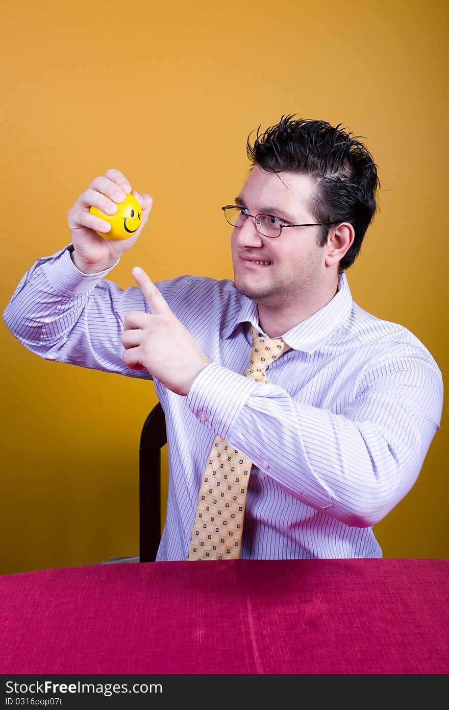 Freaky businessman starring at a tiny relax ball