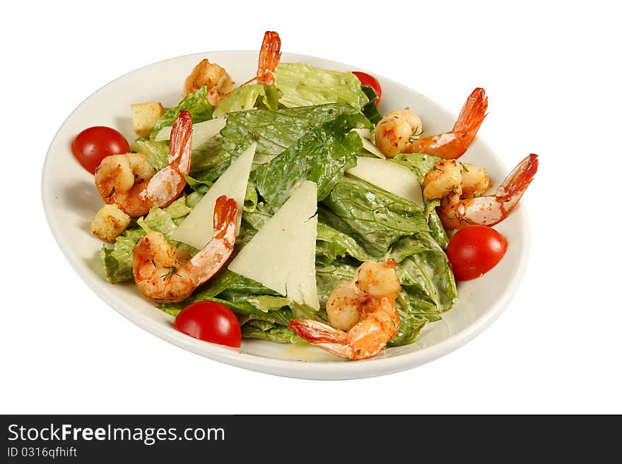 Salad with shrimp grill on white plate