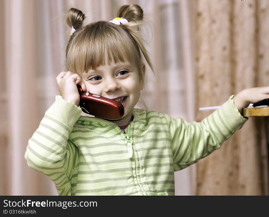 Charming little girl talking on the phone