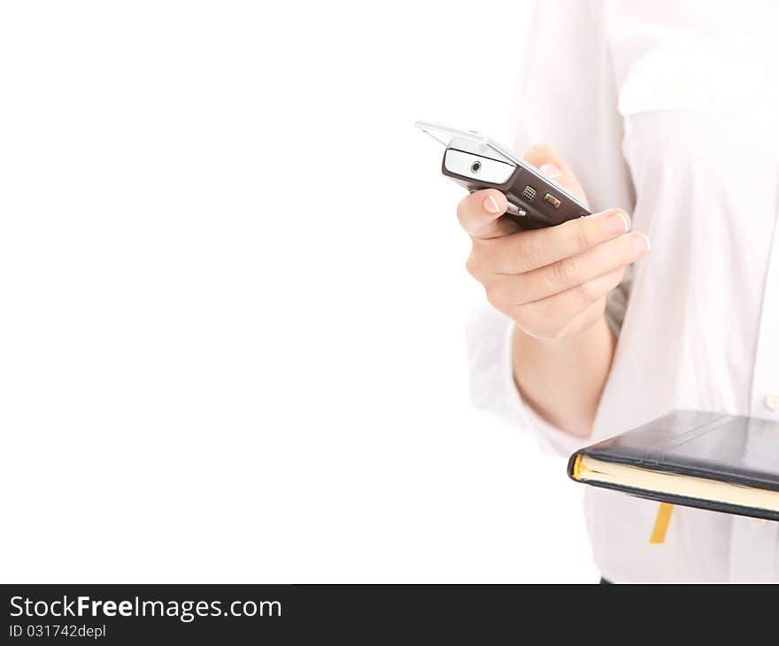 Woman holding a mobile phone and an agenda