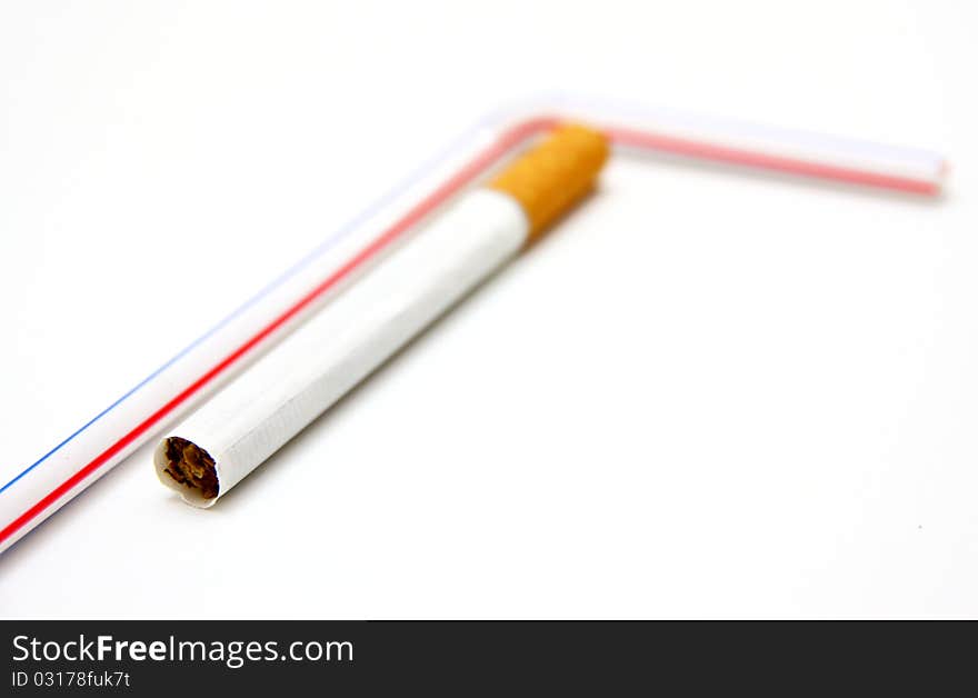 One cigaret and tubule for juice on a white background