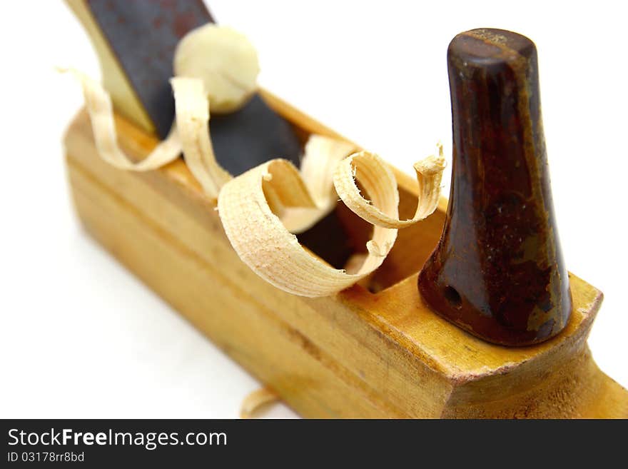 Wooden plane, boards and a shaving on a white background