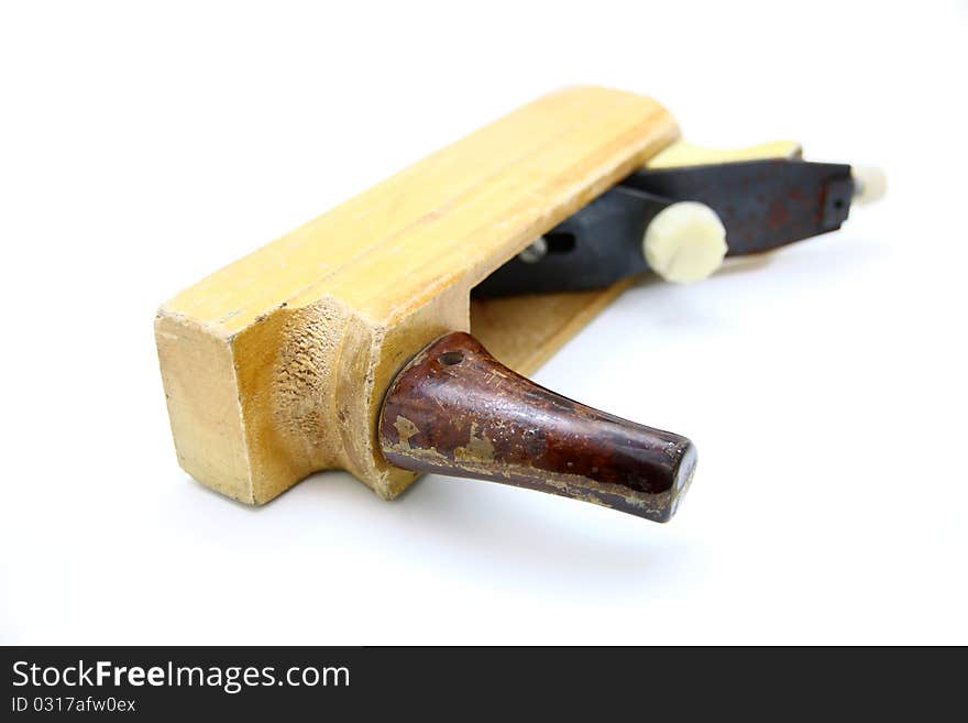 Wooden plane, boards and a shaving on a white background