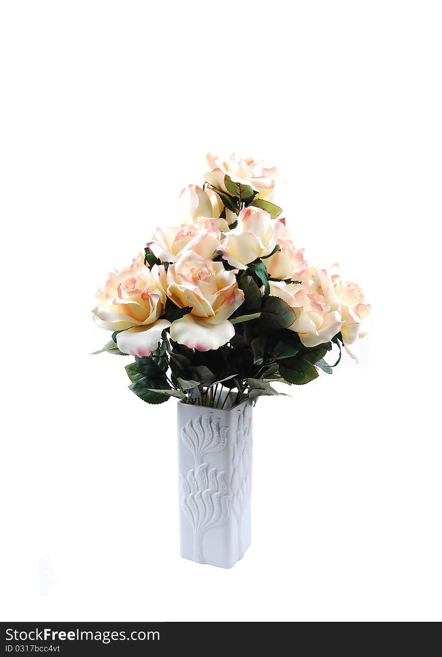 A bunch of yellow silk roses in a white vase for white background. A bunch of yellow silk roses in a white vase for white background.