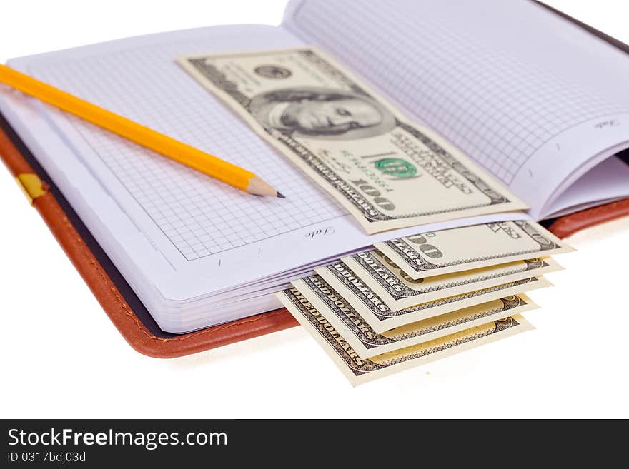 Notebook with money on white background