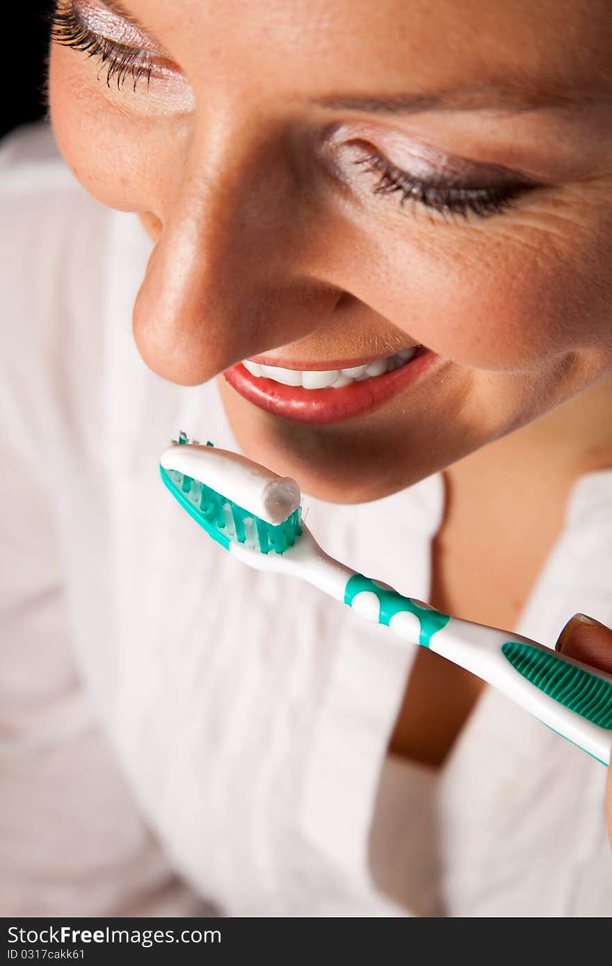 Woman healthy teeth closeup with toothbrush on black background. Woman healthy teeth closeup with toothbrush on black background