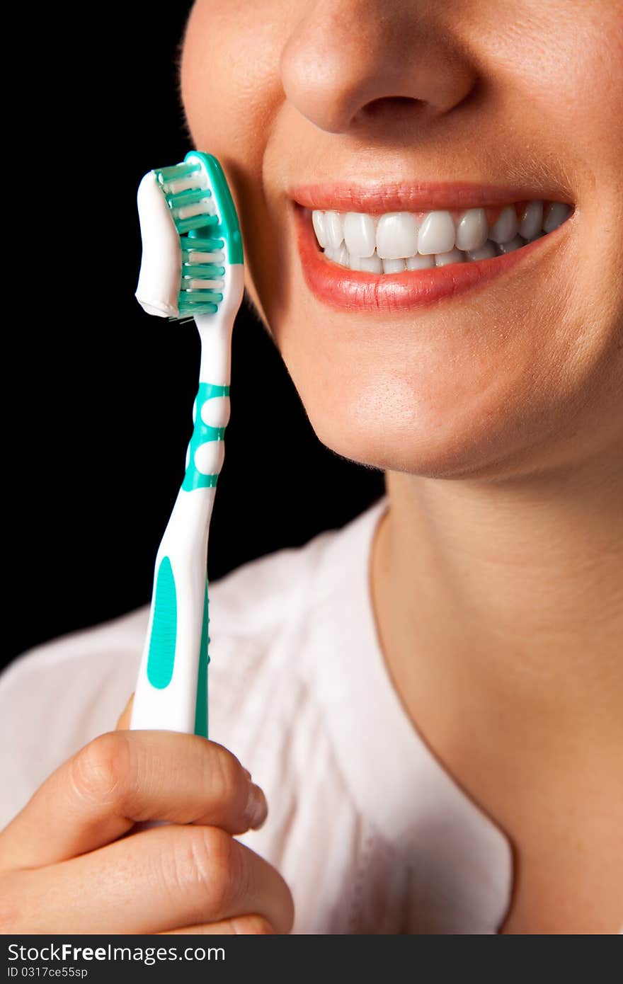 Woman healthy teeth closeup with toothbrush on black background. Woman healthy teeth closeup with toothbrush on black background