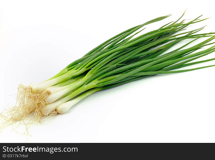 Fresh, organic leeks on white background.