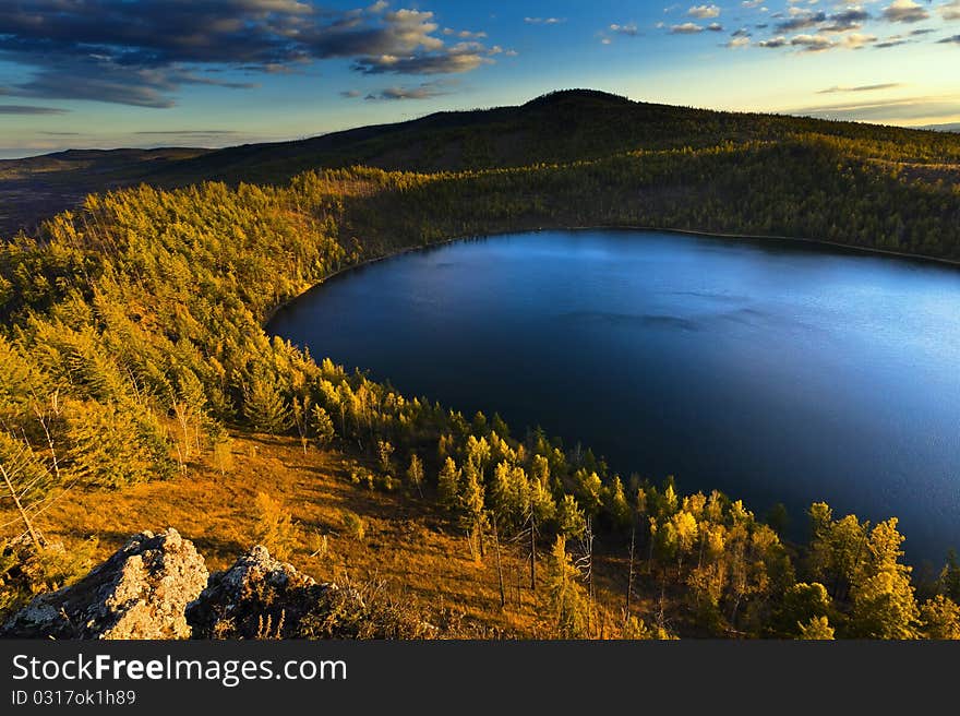 Sunset under the lake and forest