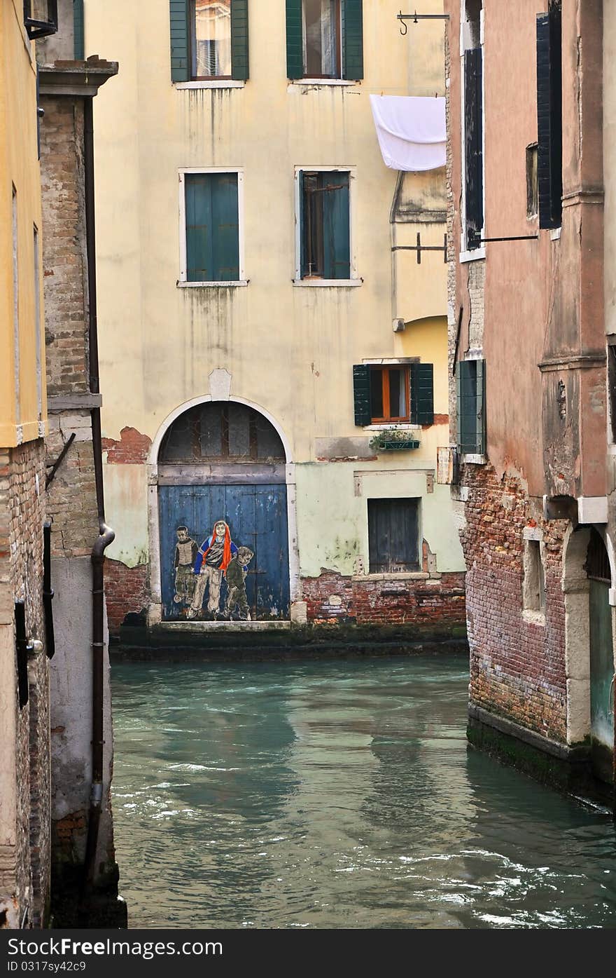 Venetian narrow channel during the daytime.