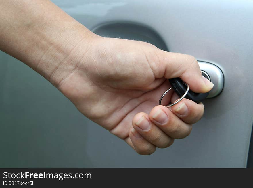 Young women open shes silver car, photo taken for new cars commercial