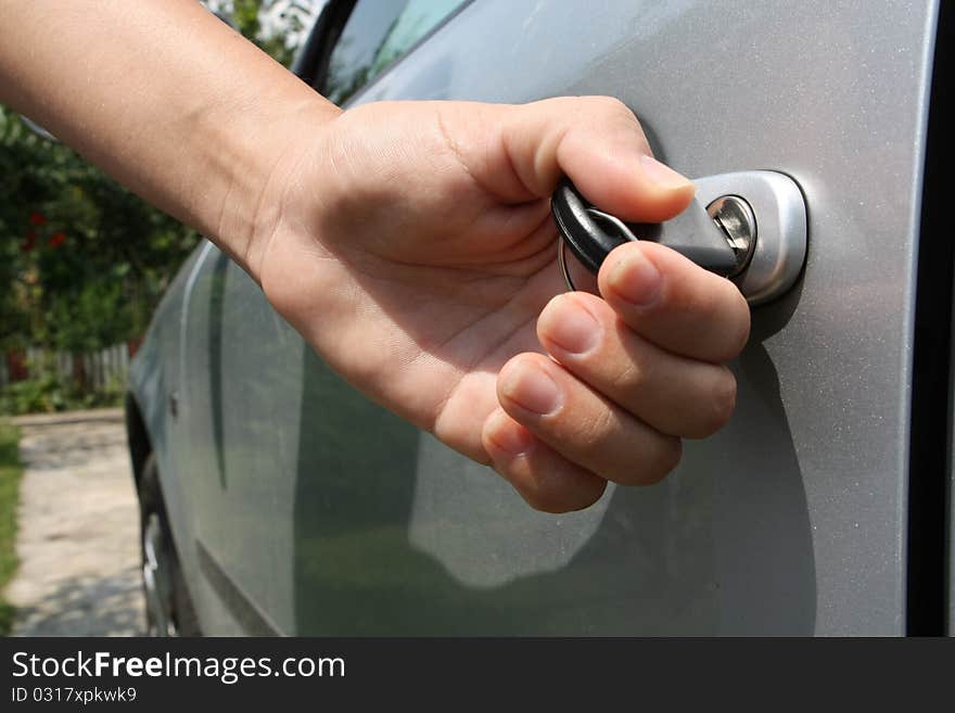 Young women open shes silver car