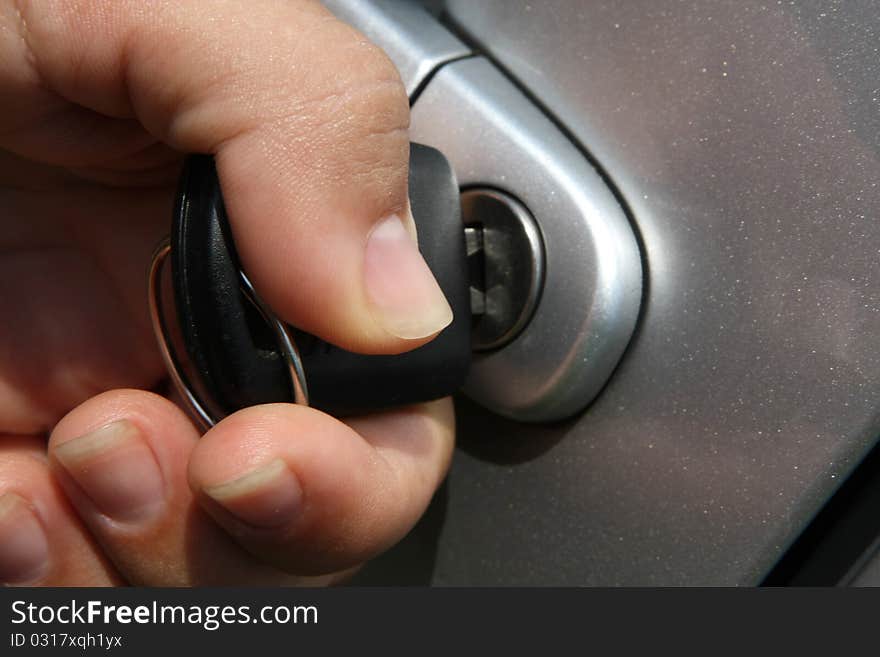 Young women open shes silver car