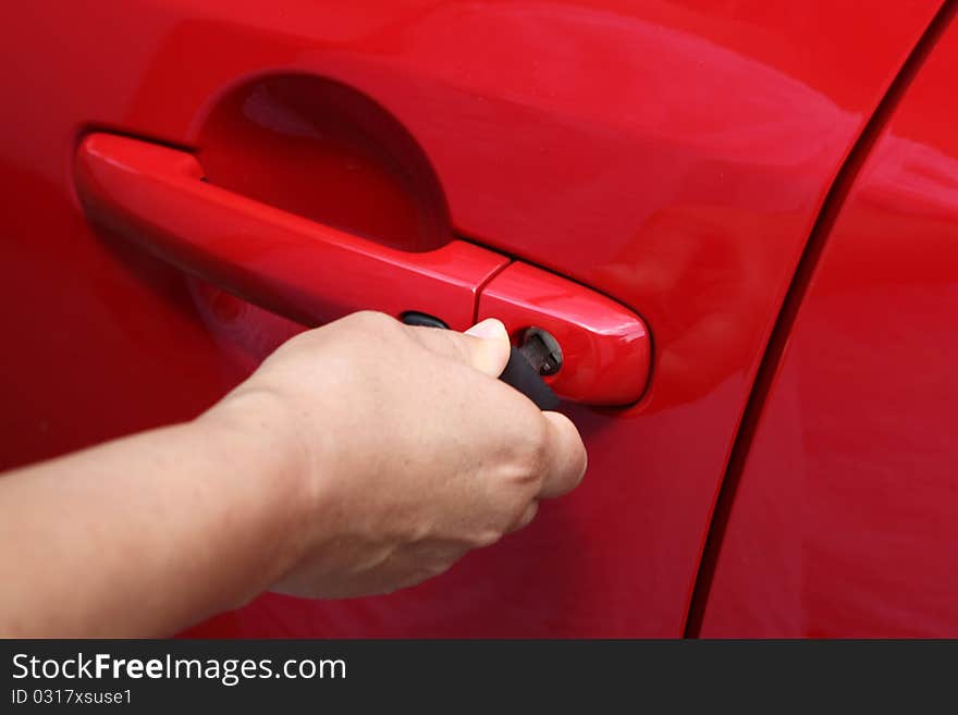 Young women open shes red car, photo taken for new cars commercial