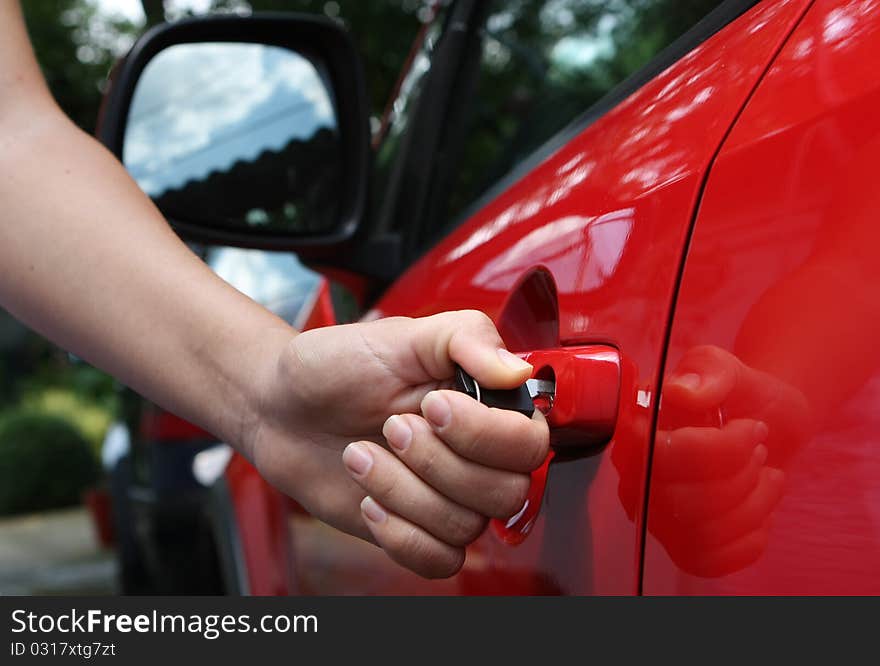 Young women open shes red car, photo taken for new cars commercial