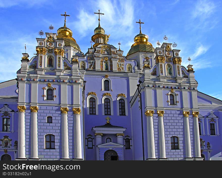 Blue cathedral with gold domes against the sky. Blue cathedral with gold domes against the sky