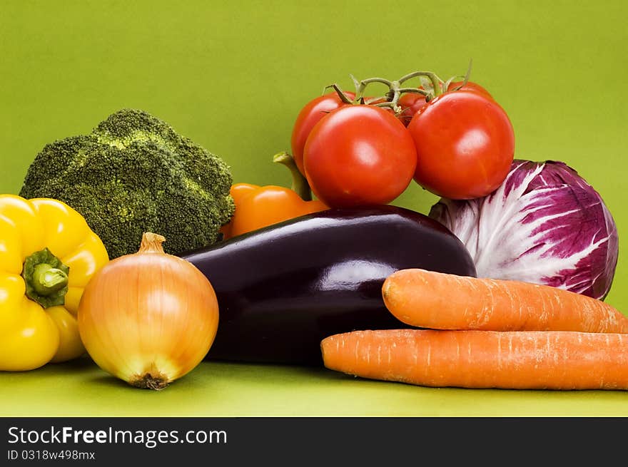 Fresh vegetables on green background