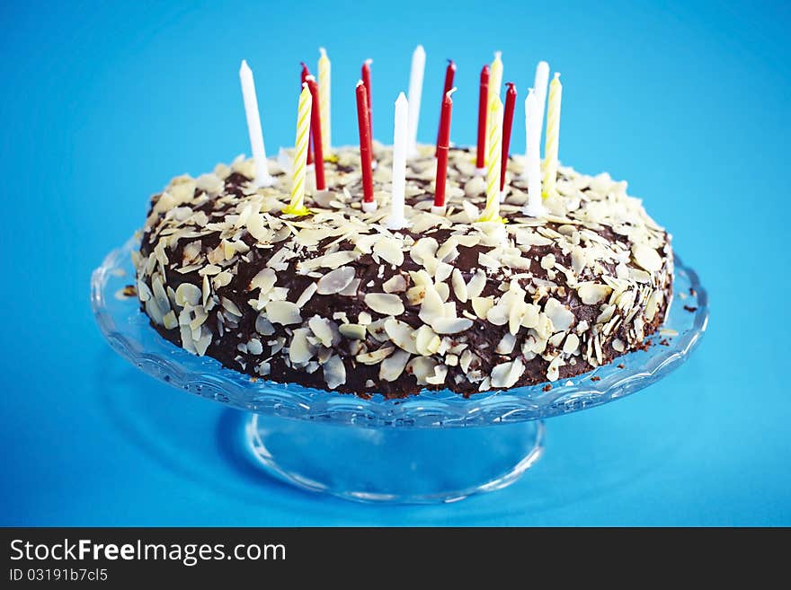 Chocolate birthday cake with flaked almonds and candles