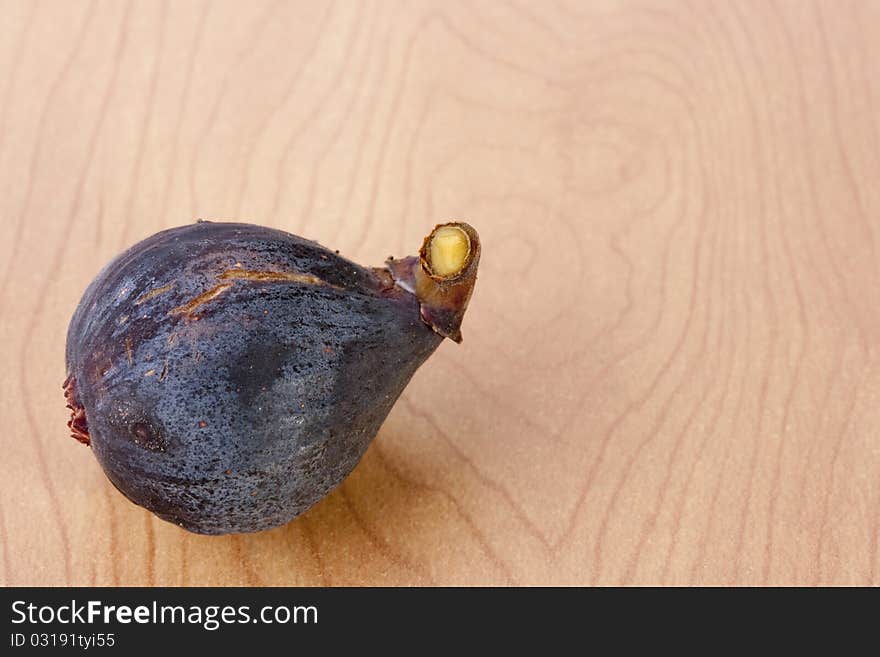 Ripe fruits of a fig on a wooden table.