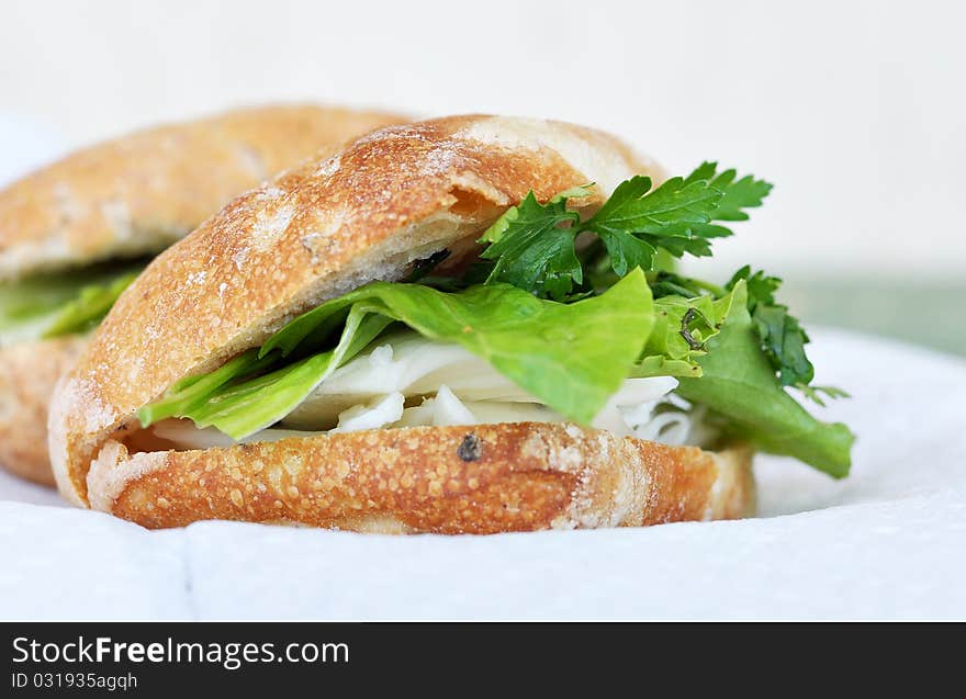 A sandwich of white cheese, lettuce and parsley. A sandwich of white cheese, lettuce and parsley.