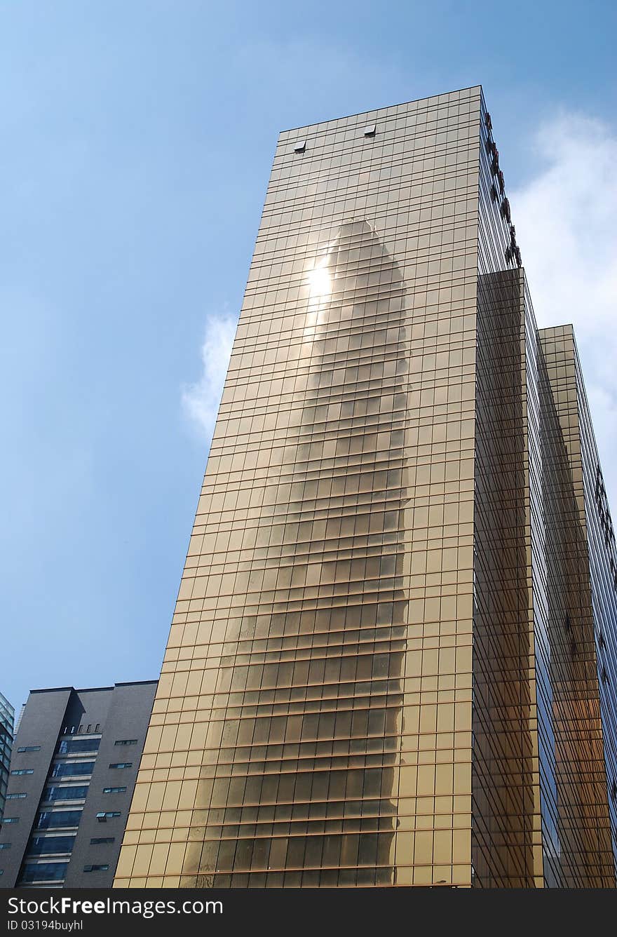 Golden office building with blue sky background in guangzhou city.