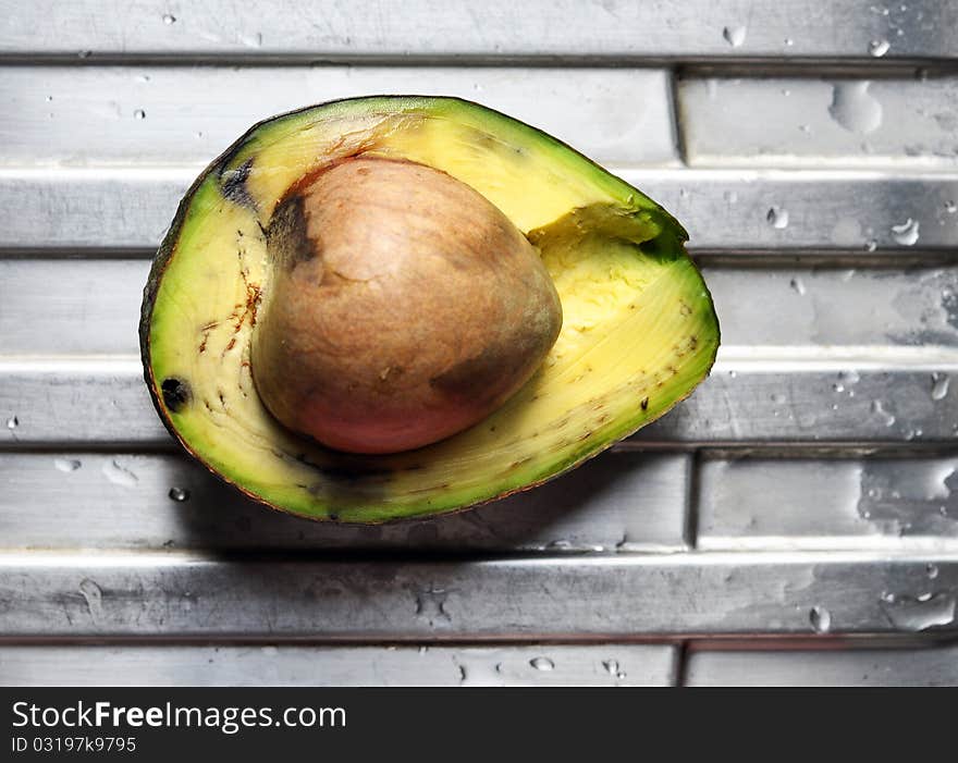 A cut avocado fruit revealing its saturated green content. A cut avocado fruit revealing its saturated green content