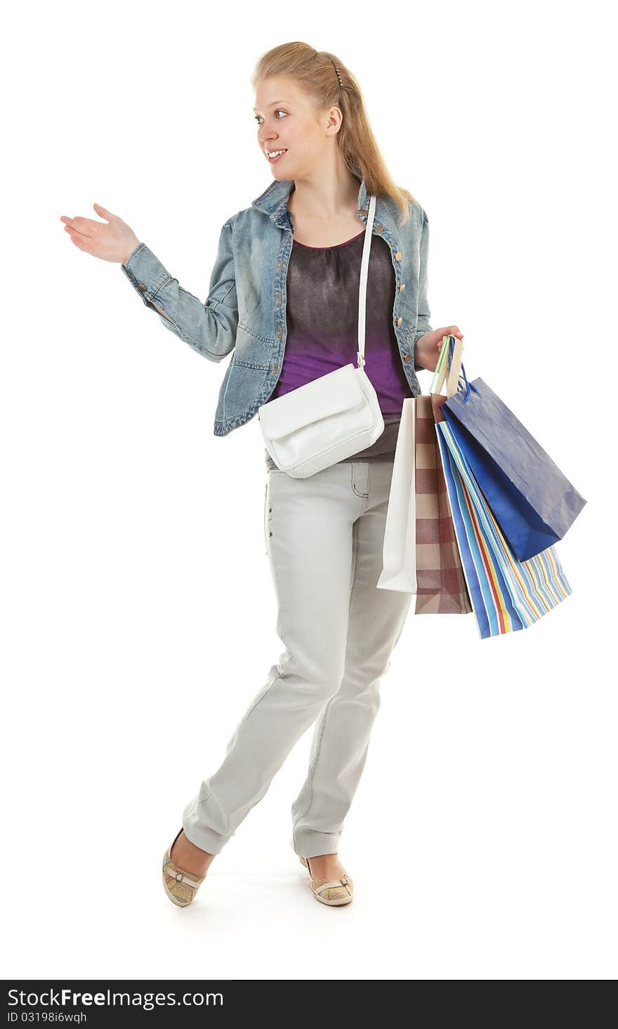 Young girl with purchases on white background