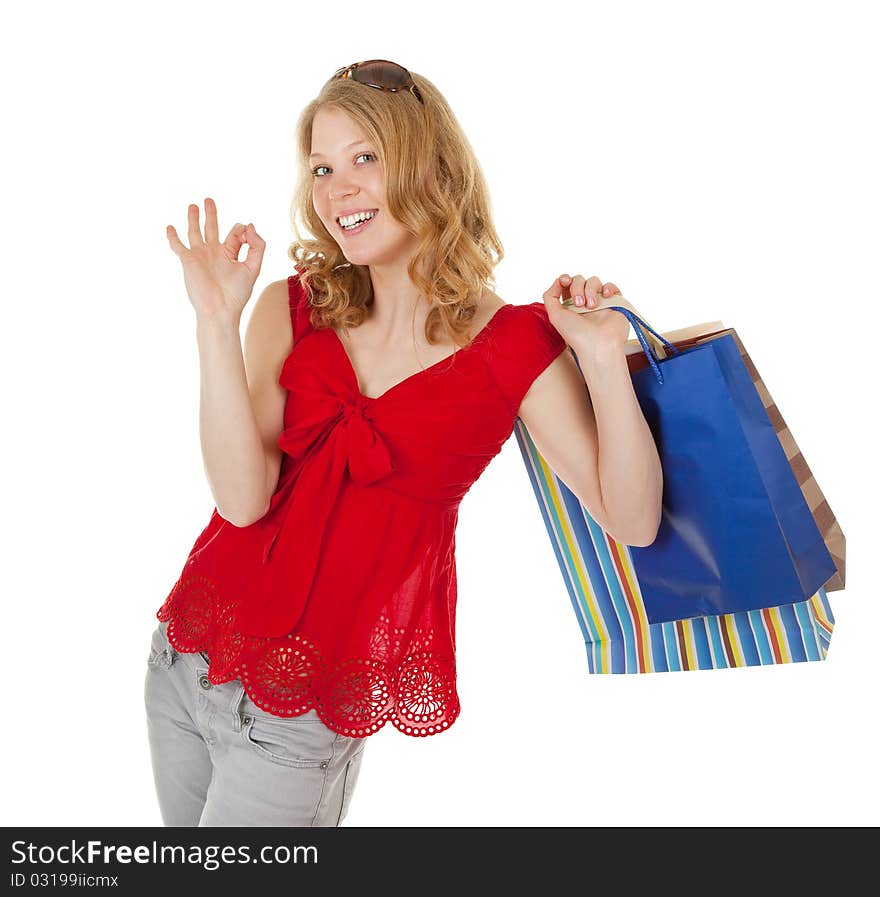 Young girl with purchases on white background