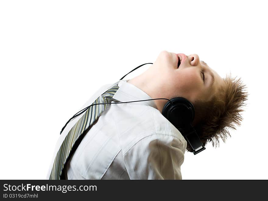 Young boy listening to head phones isolated on white