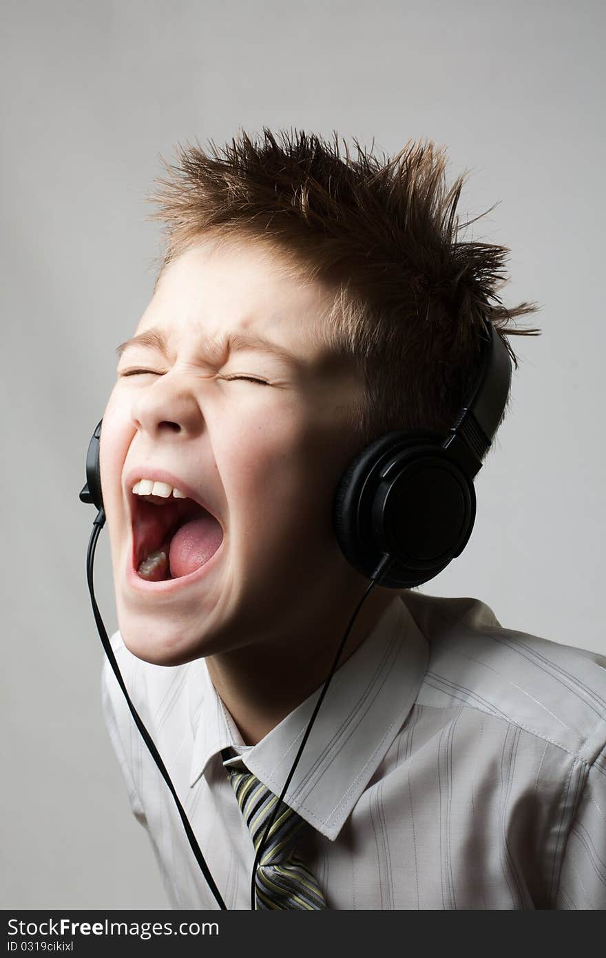 Ten year young child screaming with angry face expression isolated on white. Ten year young child screaming with angry face expression isolated on white