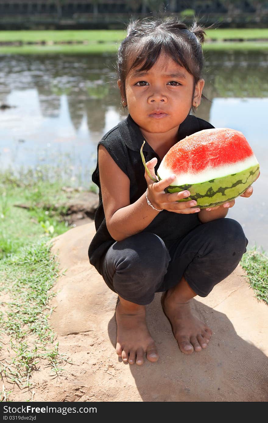 Asian girl with water melon, portrait of child holding fruit