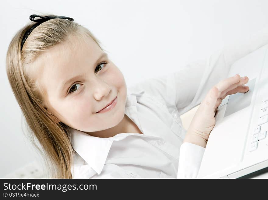 Funny cute girl with a laptop indoors. Funny cute girl with a laptop indoors