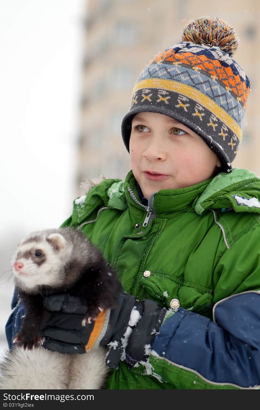 The boy holds a polecat