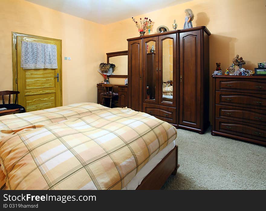 Orange Bedroom with a double wood bed