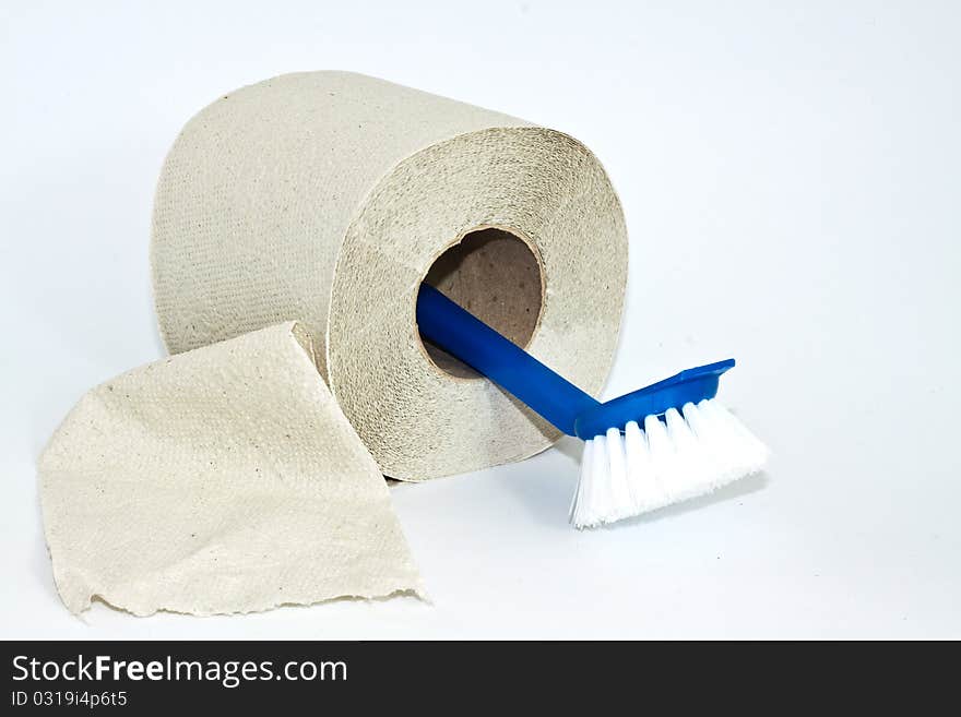 Roll of toilet paper and cleaning brush on a white background. Roll of toilet paper and cleaning brush on a white background