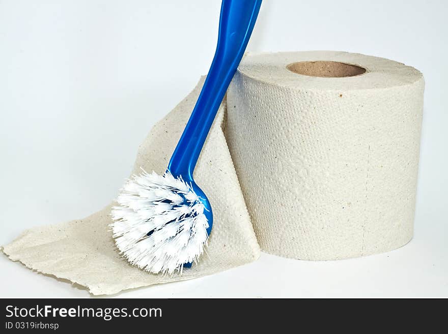 Roll of toilet paper and cleaning brush on a white background. Roll of toilet paper and cleaning brush on a white background