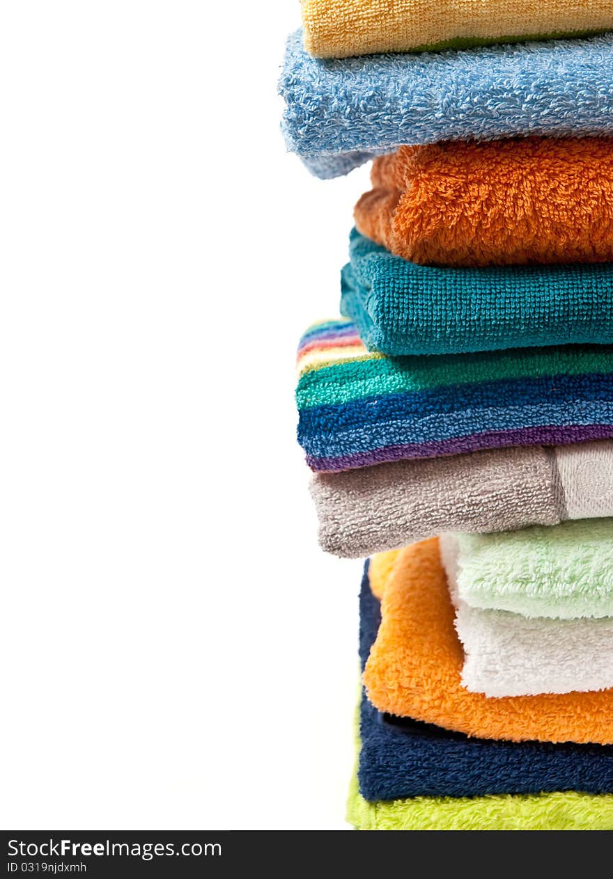 Pile of bright color towels isolated on withe background. Pile of bright color towels isolated on withe background