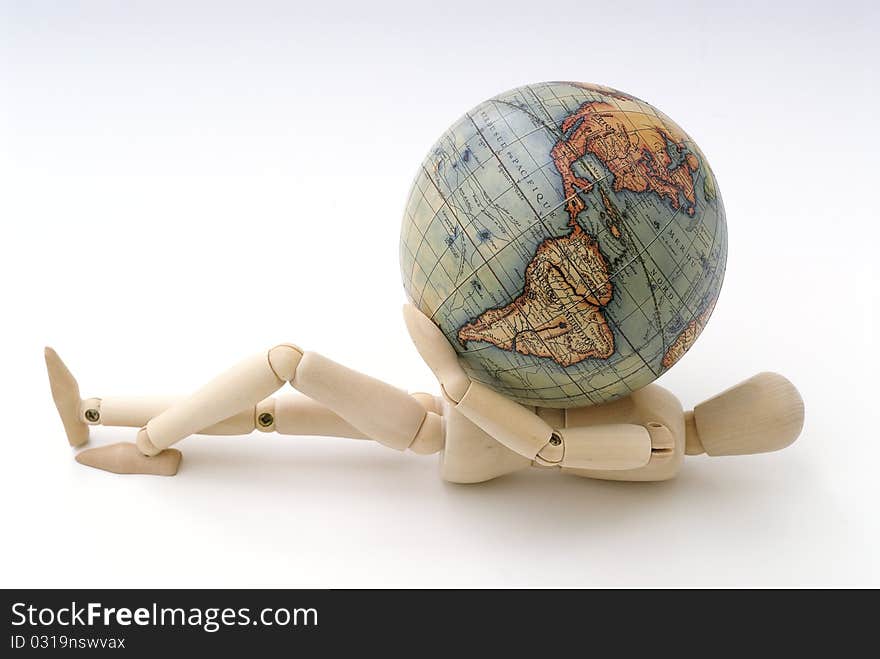 Wooden dummy lying on the chest with a globe. Wooden dummy lying on the chest with a globe