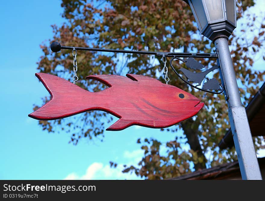 The Red Fish sign board on the street lamp