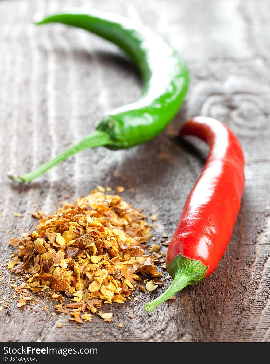 Fresh chili with chili seeds on wooden table