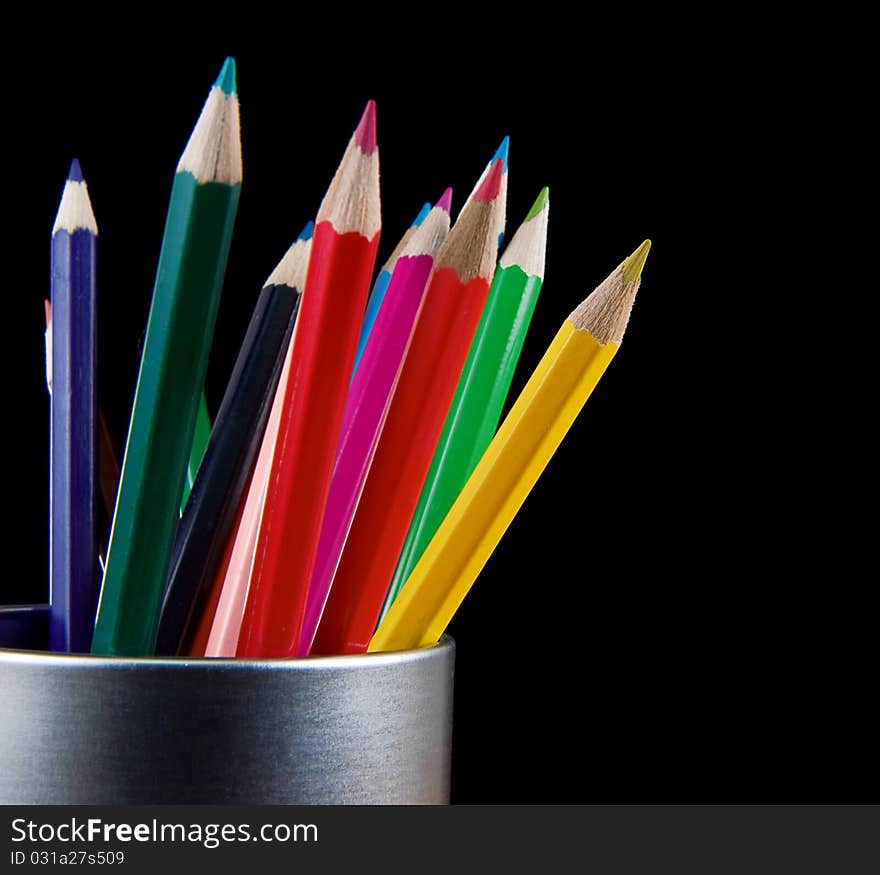 Holder Full Of Colorful Pencils Isolated On Black